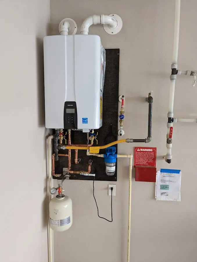 Professional plumber installing copper piping in a Muskogee home